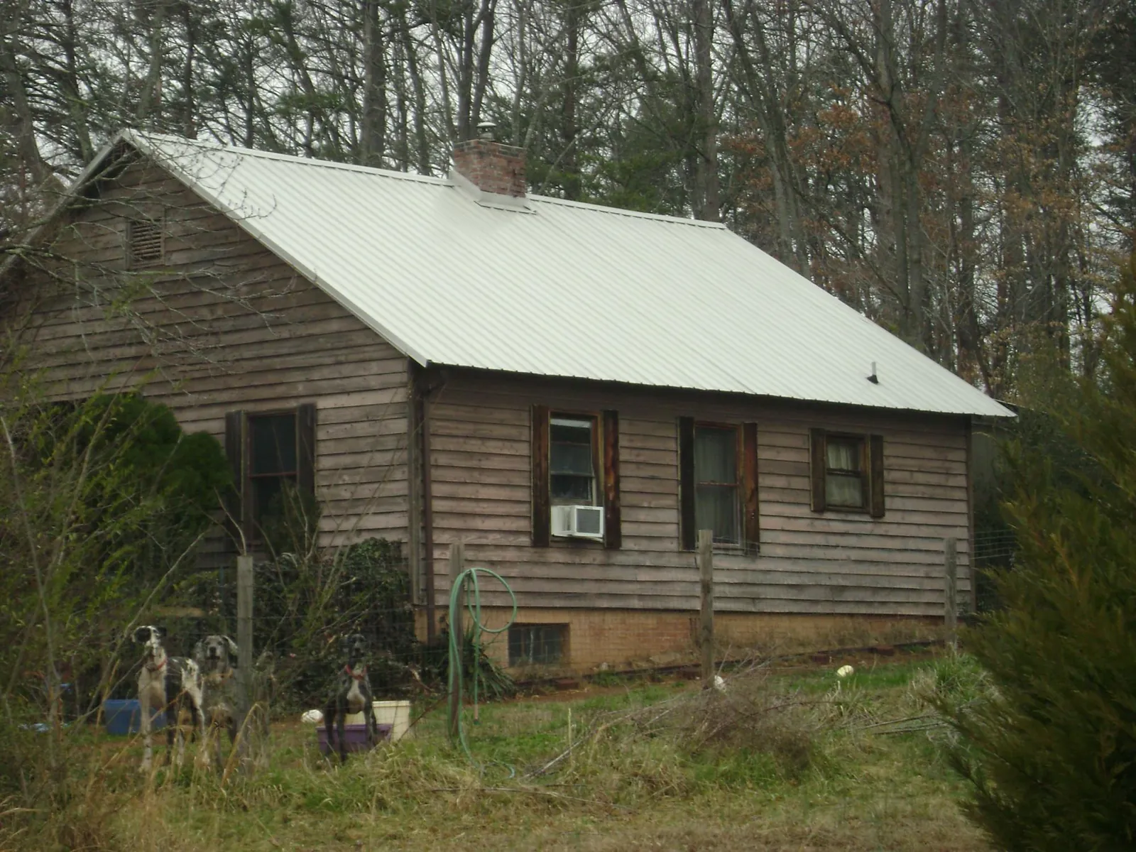 White metal roof on an old wood sided farmhouse, from a Metal Roof Installation job in Upperco